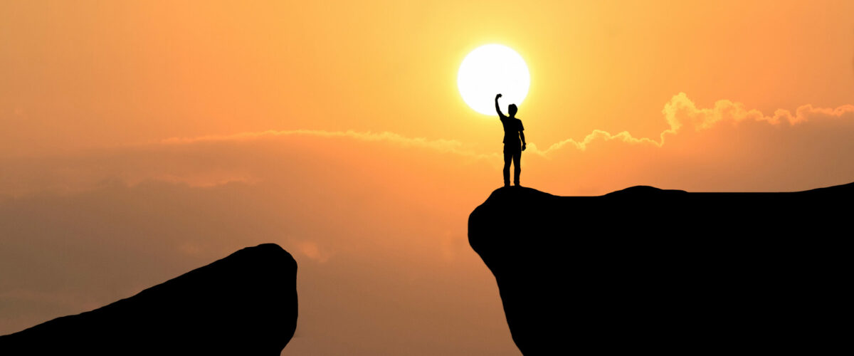 Man on top of mountain ,Freedom man on sunset background