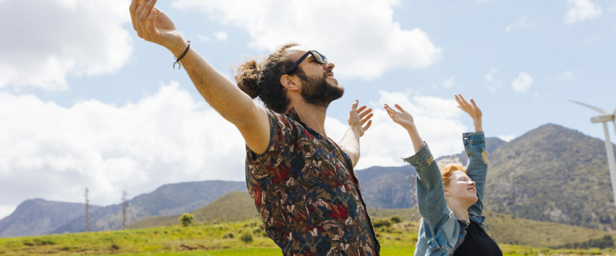 young-couple-with-hands-up-nature